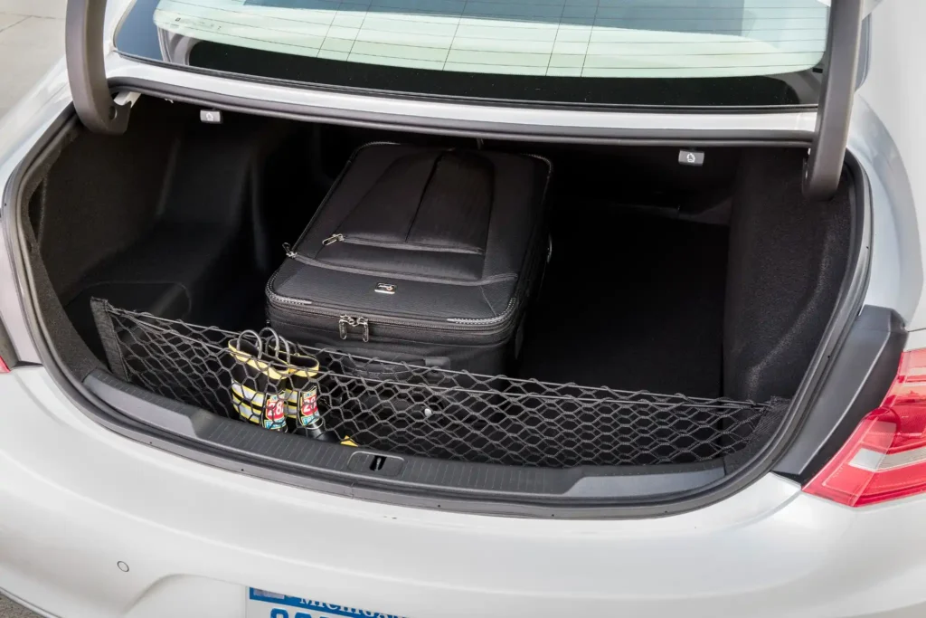 2017 Buick LaCrosse open trunk space with luggage and cargo net showcasing storage capacity 2017 Buick LaCrosse open trunk space with luggage and cargo net showcasing storage capacity