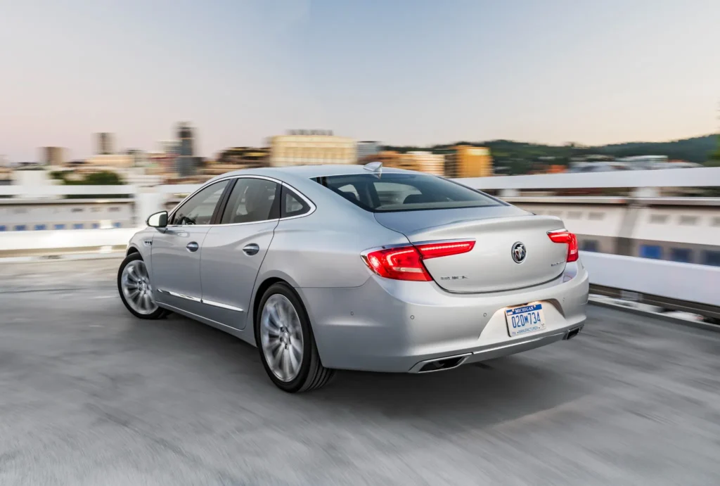 2017 Buick LaCrosse rear three quarter view driving on highway LED tail lights and dual exhaust visible 2017 Buick LaCrosse rear three quarter view driving on highway LED tail lights and dual exhaust visible