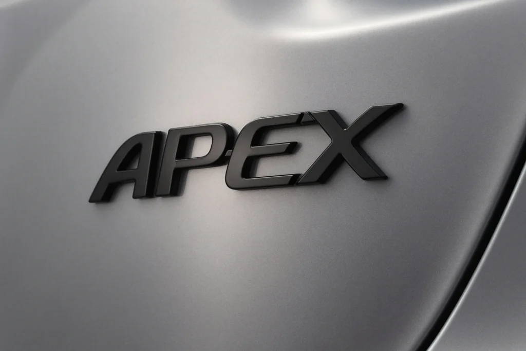 APEX badge close up on 2022 Toyota Corolla Apex sedan featuring blacked out lettering against sleek silver metallic paint finish APEX badge close up on 2022 Toyota Corolla Apex sedan featuring blacked out lettering against sleek silver metallic paint finish