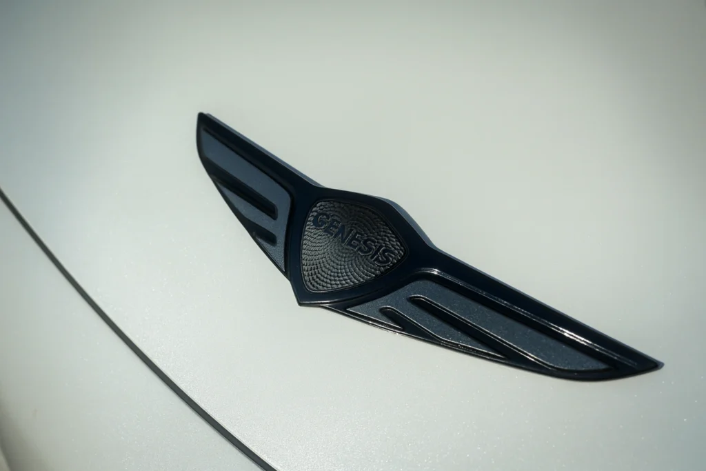 Close up of Genesis GV60 front emblem on hood Close up of Genesis GV60 front emblem on hood