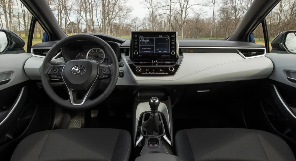 Cockpit of 2022 Toyota Corolla Apex with leather wrapped steering wheel manual transmission shifter touchscreen display and sporty dashboard Cockpit of 2022 Toyota Corolla Apex with leather wrapped steering wheel manual transmission shifter touchscreen display and sporty dashboard