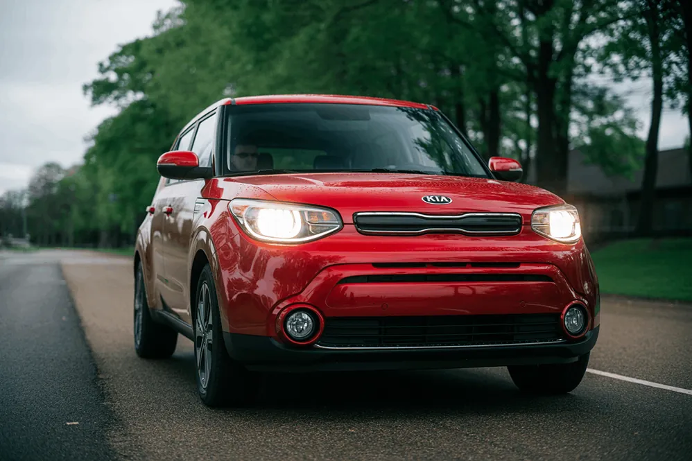 2017 kia soul front view with headlights on, sporty compact suv appearance highlighted by bold red paint