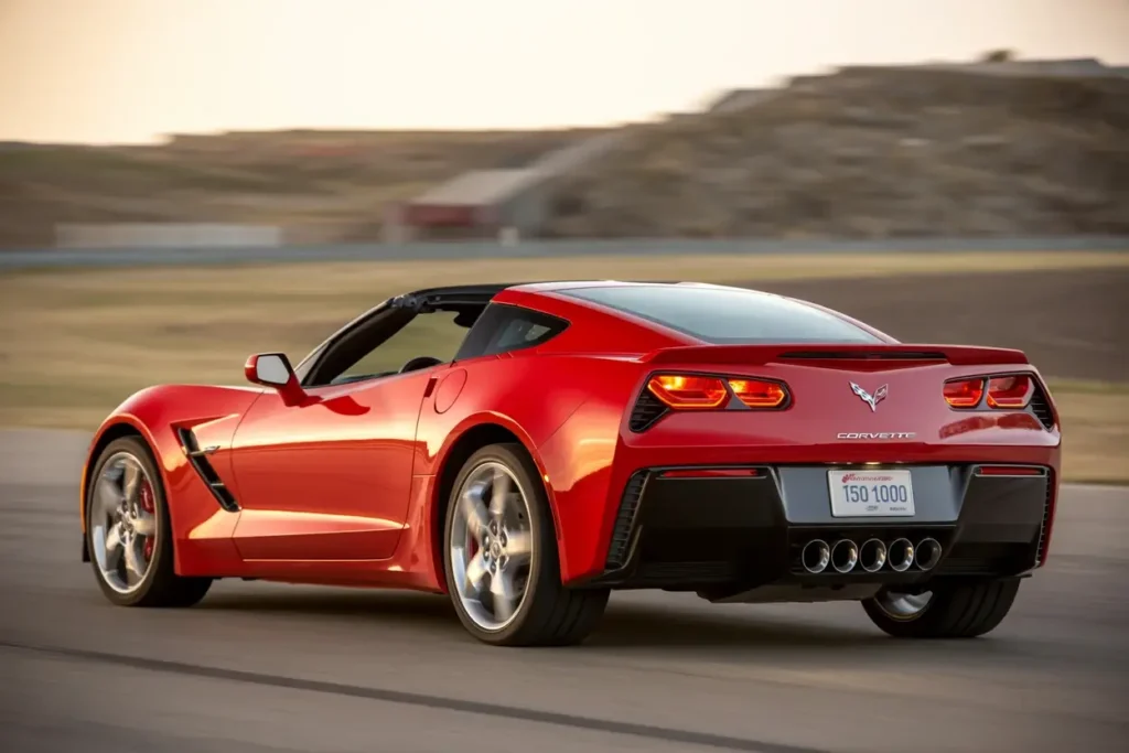 2014 Corvette Stingray Z51 Convertible accelerating on racetrack rear three quarter LED taillights glowing quad pipes sculpted sides dynamic handling 2014 Corvette Stingray Z51 Convertible accelerating on racetrack rear three quarter LED taillights glowing quad pipes sculpted sides dynamic handling