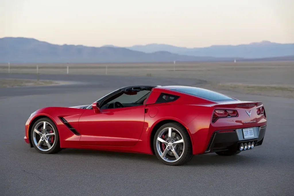 2014 Corvette Stingray Z51 Convertible angled rear view at dusk chrome alloy wheels subtle spoiler muscular fenders performance exhaust tips 2014 Corvette Stingray Z51 Convertible angled rear view at dusk chrome alloy wheels subtle spoiler muscular fenders performance exhaust tips