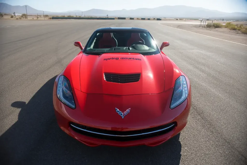 2014 Corvette Stingray Z51 Convertible overhead front view on track hood vent Spring Mountain branding aerodynamic lines aggressive sports styling 2014 Corvette Stingray Z51 Convertible overhead front view on track hood vent Spring Mountain branding aerodynamic lines aggressive sports styling