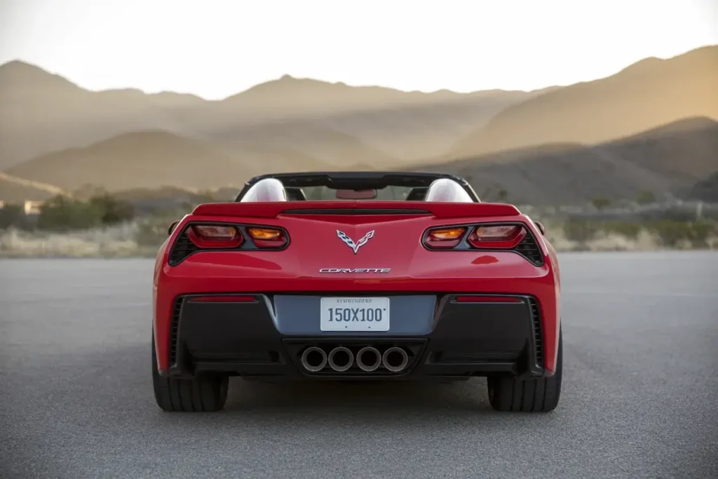 2014 Corvette Stingray Z51 Convertible rear view on open road roof down signature quad exhaust sculpted bumper sporty LED taillamps 2014 Corvette Stingray Z51 Convertible rear view on open road roof down signature quad exhaust sculpted bumper sporty LED taillamps