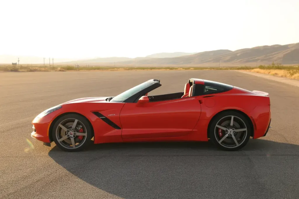 2014 Corvette Stingray Z51 Convertible side profile roof down red paint five spoke rims long hood athletic proportions on racetrack 2014 Corvette Stingray Z51 Convertible side profile roof down red paint five spoke rims long hood athletic proportions on racetrack