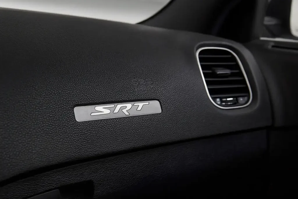 2016 Dodge Charger SRT dashboard with metallic SRT badge beside right side air vent and textured soft touch trim 2016 Dodge Charger SRT dashboard with metallic SRT badge beside right side air vent and textured soft touch trim