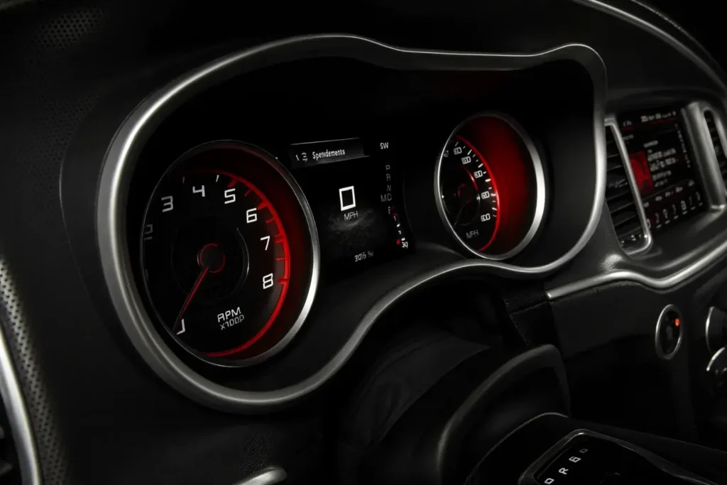 2016 Dodge Charger SRT performance gauge cluster with red backlighting tachometer and digital speedometer display at zero MPH 2016 Dodge Charger SRT performance gauge cluster with red backlighting tachometer and digital speedometer display at zero MPH