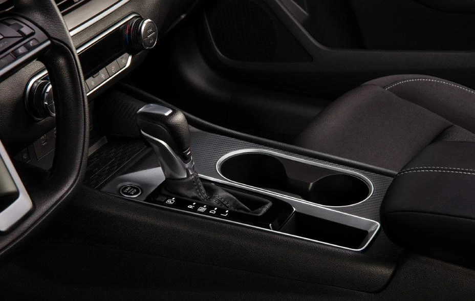 2025 Nissan Altima SR center console close up studio lighting CVT gear shifter with textured trim dual cupholders storage bin 2025 Nissan Altima SR center console close up studio lighting CVT gear shifter with textured trim dual cupholders storage bin