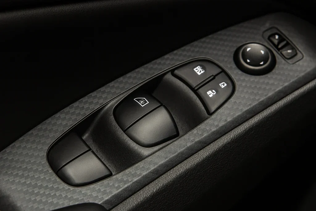 2025 Nissan Altima SR door panel close up studio light carbon look trim with power window switches mirror control lock buttons e1761877545146 2025 Nissan Altima SR door panel close up studio light carbon look trim with power window switches mirror control lock buttons e1761877545146