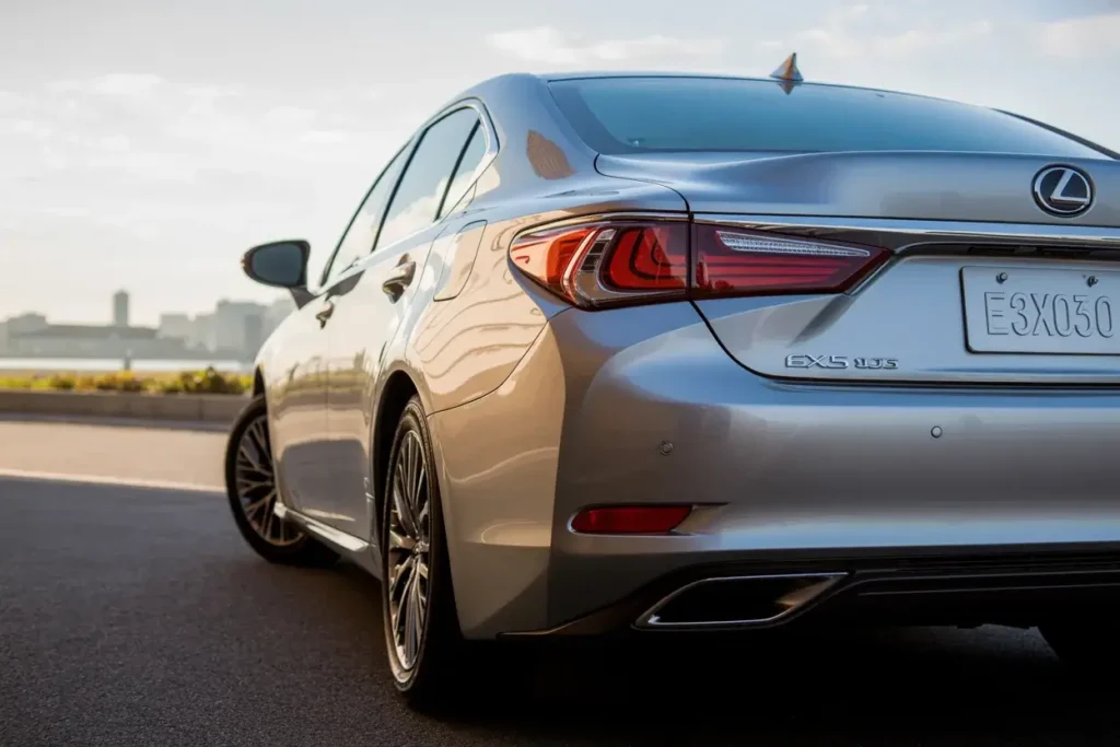 Close rear angle of Lexus ES 350 F Sport emphasizing dual exhausts LED taillights and sleek metallic silver body design Close rear angle of Lexus ES 350 F Sport emphasizing dual exhausts LED taillights and sleek metallic silver body design