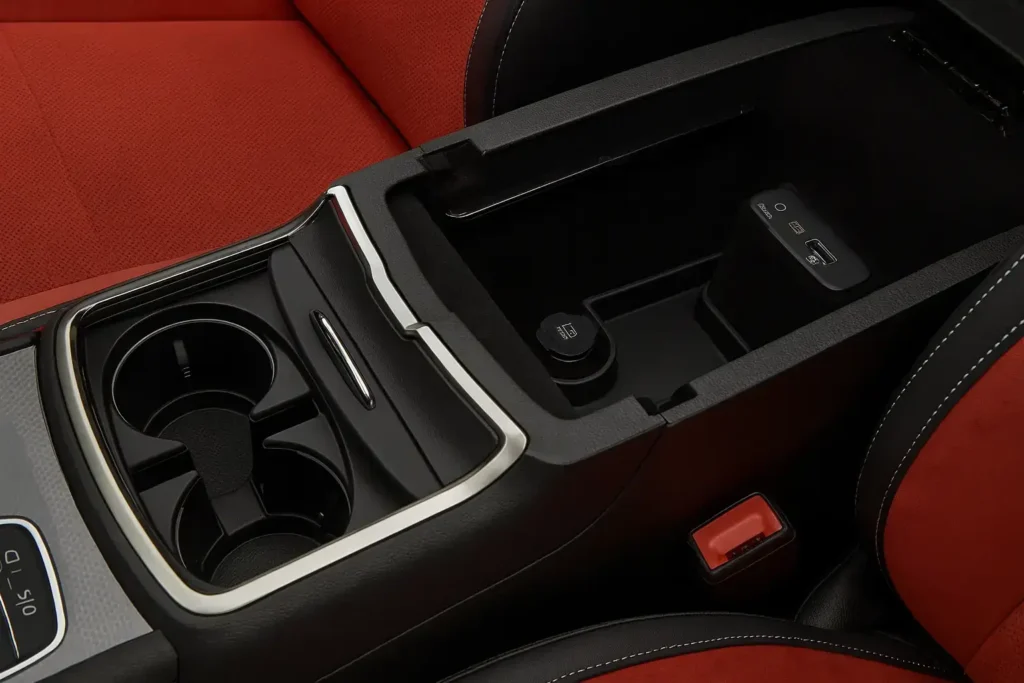 Close up of 2016 Dodge Charger RT center console showing dual cup holders USB ports and premium black red stitching detail Close up of 2016 Dodge Charger RT center console showing dual cup holders USB ports and premium black red stitching detail