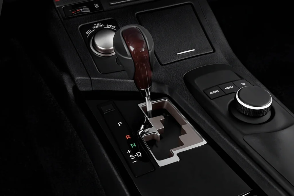 Close up center console of 2013 Lexus ES 350 automatic shifter drive mode selector and multimedia controller in dark interior Close up center console of 2013 Lexus ES 350 automatic shifter drive mode selector and multimedia controller in dark interior