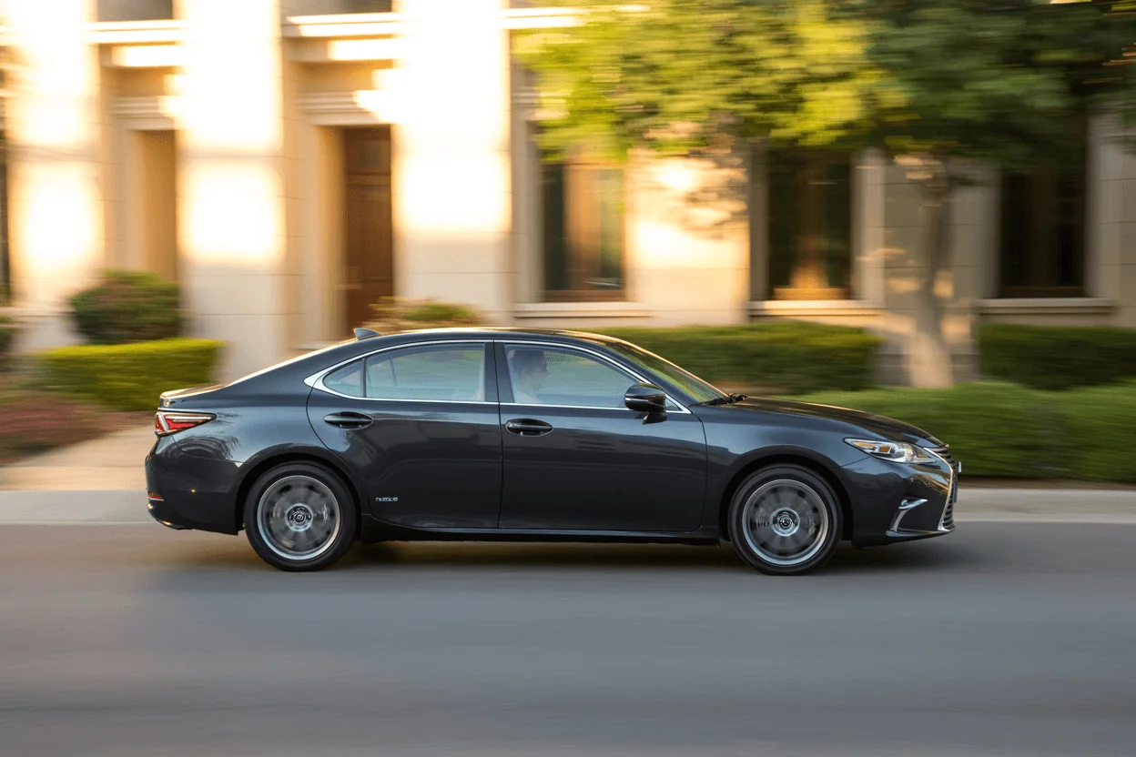Side profile motion shot of 2013 Lexus ES 350 sedan passing upscale buildings emphasizing body lines and alloy wheels Side profile motion shot of 2013 Lexus ES 350 sedan passing upscale buildings emphasizing body lines and alloy wheels