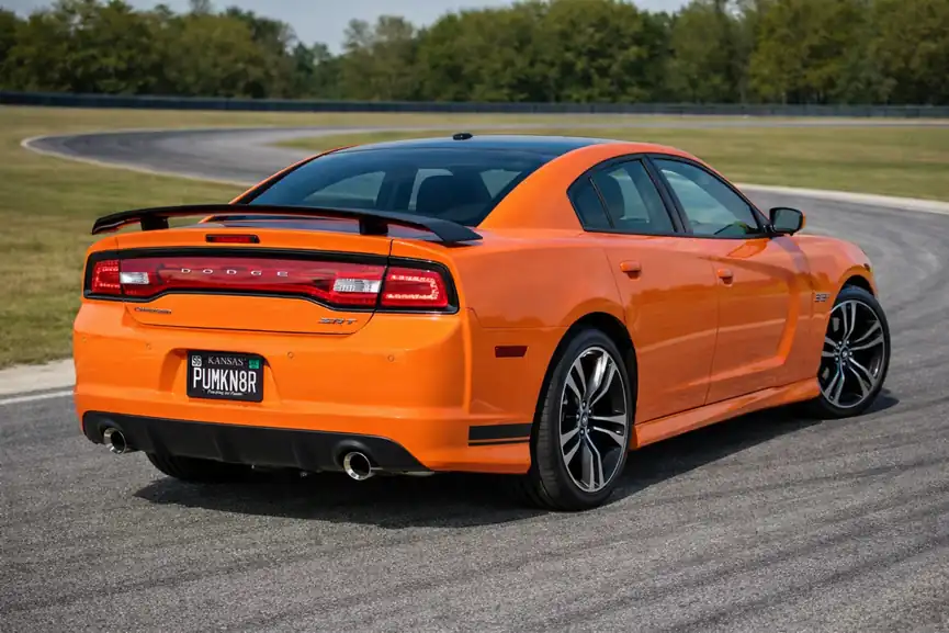 2014 Dodge Charger SRT8 Super Bee rear three quarter view with spoiler and dual exhaust on track 2014 Dodge Charger SRT8 Super Bee rear three quarter view with spoiler and dual exhaust on track