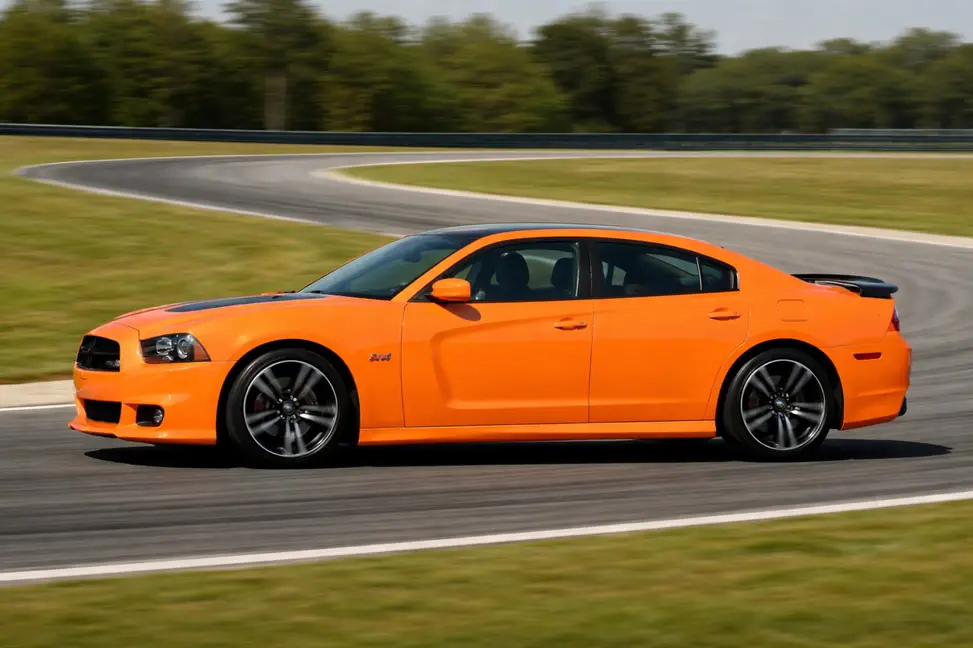 2014 Dodge Charger SRT8 Super Bee side panning view rounding racetrack bend with rear spoiler 2014 Dodge Charger SRT8 Super Bee side panning view rounding racetrack bend with rear spoiler