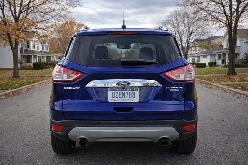2016 Ford Escape Titanium rear straight on view with chrome liftgate applique wraparound taillights dual exhaust fall neighborhood road 2016 Ford Escape Titanium rear straight on view with chrome liftgate applique wraparound taillights dual exhaust fall neighborhood road
