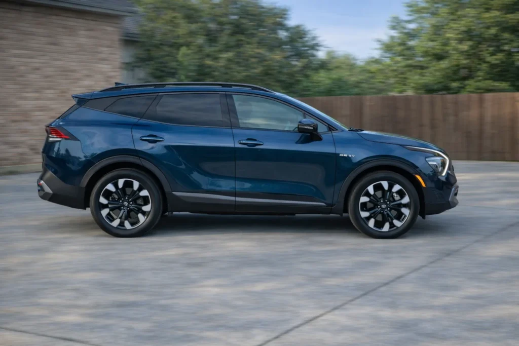 2023 Kia Sportage Plug in Hybrid panning driver side profile on driveway with motion blur 2023 Kia Sportage Plug in Hybrid panning driver side profile on driveway with motion blur