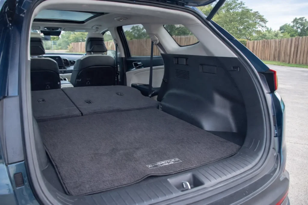 2023 Kia Sportage Plug in Hybrid rear cargo area view from open liftgate with seats folded flat 2023 Kia Sportage Plug in Hybrid rear cargo area view from open liftgate with seats folded flat