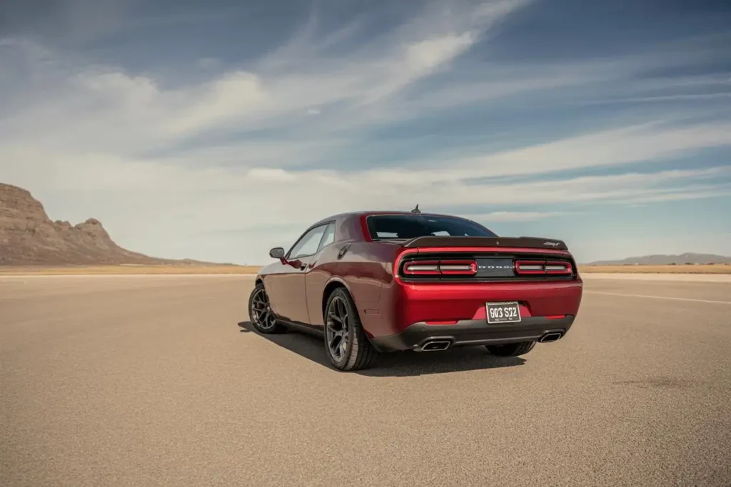 Angled rear view of 2015 Dodge Challenger SRT 392 sports coupe in deep red moun Angled rear view of 2015 Dodge Challenger SRT 392 sports coupe in deep red moun