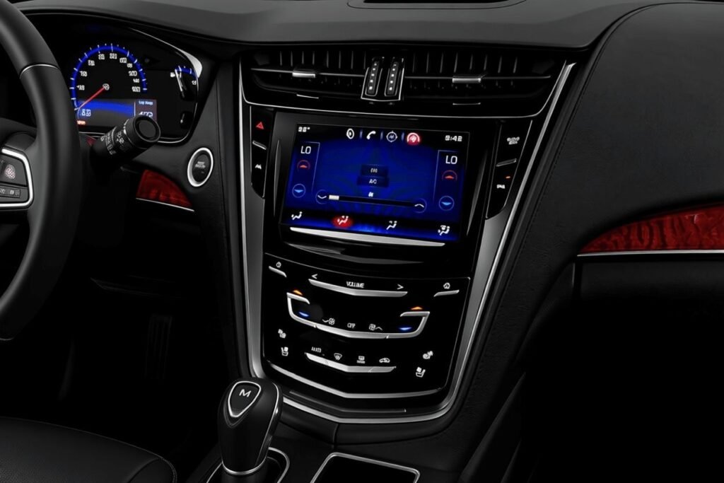 Center stack view in 2016 Cadillac CTS CUE touchscreen climate controls gloss black trim and nearby manual mode gear selector Center stack view in 2016 Cadillac CTS CUE touchscreen climate controls gloss black trim and nearby manual mode gear selector
