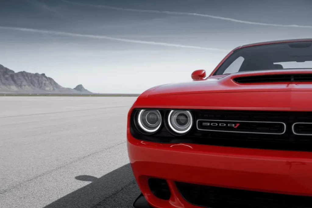 Front close up of 2015 Dodge Challenger SRT 392 in TorRed on desert runway emph Front close up of 2015 Dodge Challenger SRT 392 in TorRed on desert runway emph
