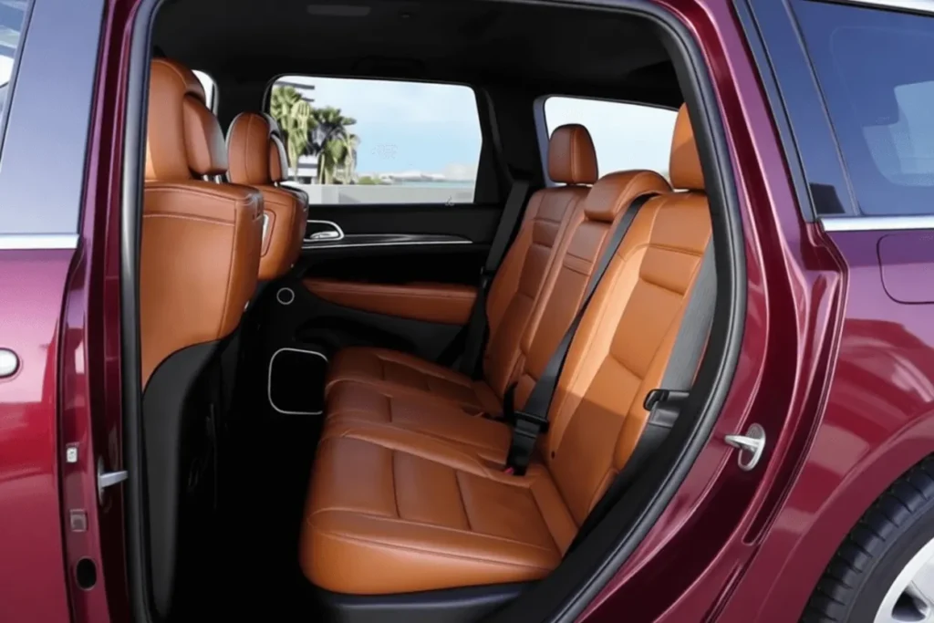 Rear seat view of 2016 Jeep Grand Cherokee SRT tan leather bench and door trim open door showing skyline Rear seat view of 2016 Jeep Grand Cherokee SRT tan leather bench and door trim open door showing skyline