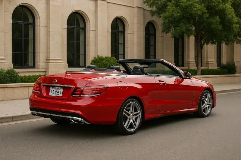 Rear three quarter angle of 2015 Mercedes Benz E400 Cabriolet top down LED taillights chrome exhaust tips urban curb Rear three quarter angle of 2015 Mercedes Benz E400 Cabriolet top down LED taillights chrome exhaust tips urban curb