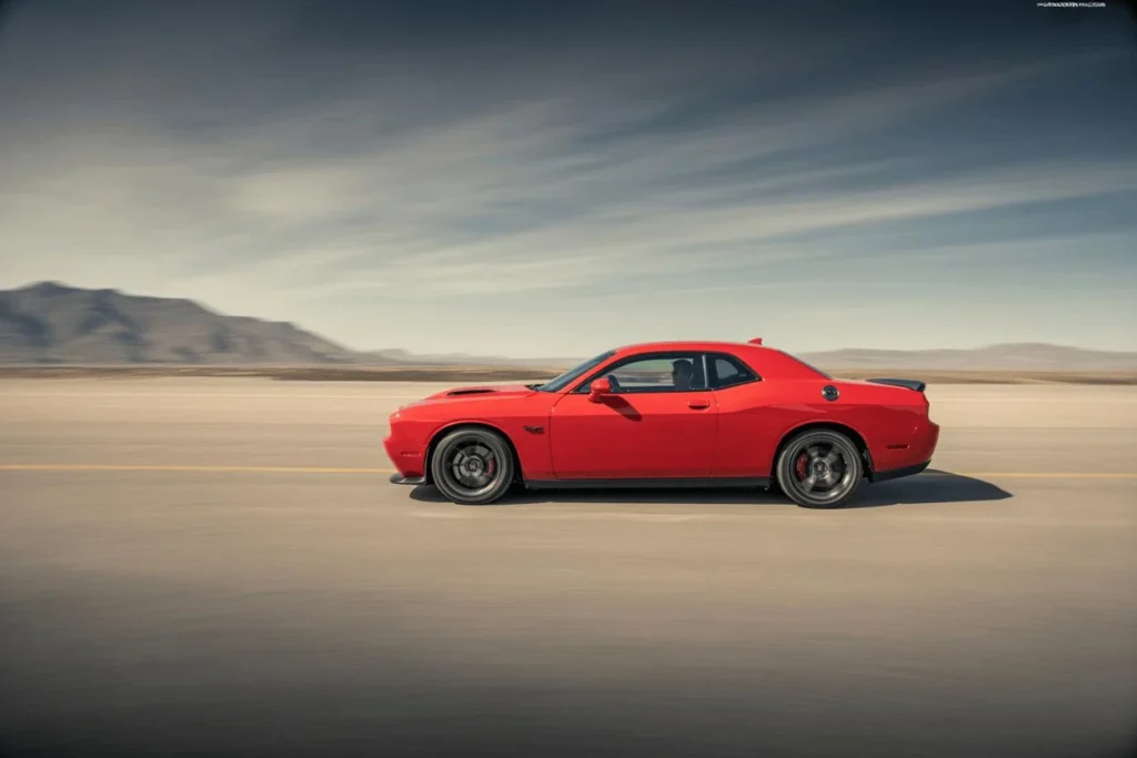 Rear three quarter shot of 2015 Dodge Challenger SRT 392 in metallic red wide stance quad exhaust and LED lightbar Rear three quarter shot of 2015 Dodge Challenger SRT 392 in metallic red wide stance quad exhaust and LED lightbar