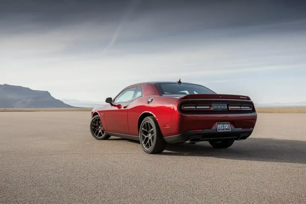 Rear three quarter view of 2015 Dodge Challenger SRT 392 in red on deserted runway showing LED taillights and dual exhaust Rear three quarter view of 2015 Dodge Challenger SRT 392 in red on deserted runway showing LED taillights and dual exhaust