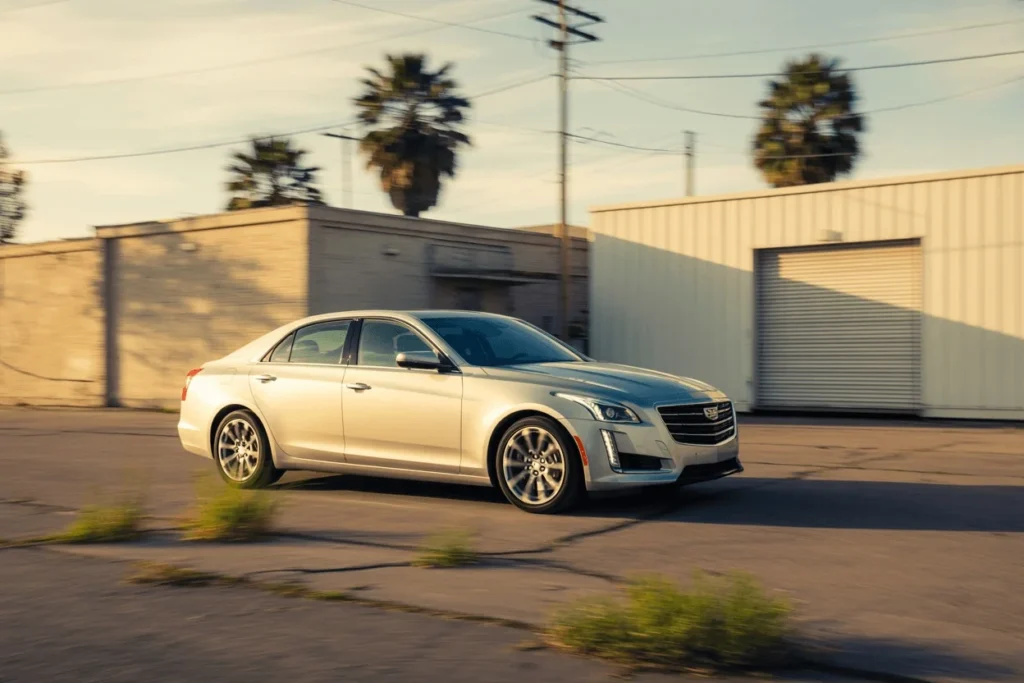 Side profile motion shot of 2016 Cadillac CTS luxury sedan driving through industrial street emphasizing wheels stance and body lines Side profile motion shot of 2016 Cadillac CTS luxury sedan driving through industrial street emphasizing wheels stance and body lines